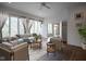 Bright living room with multiple windows, wood floors, neutral furniture, and stylish décor at 10628 Walnut Creek W Dr, Carmel, IN 46032