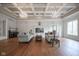 Large living room with hardwood floors, coffered ceiling and exquisite chandeliers at 10628 Walnut Creek W Dr, Carmel, IN 46032