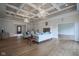 Bright living room with coffered ceiling, chandeliers, fireplace, and wood floors at 10628 Walnut Creek W Dr, Carmel, IN 46032
