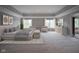 Spacious main bedroom boasts serene decor, plush seating, and soft natural light creating a relaxing retreat at 10628 Walnut Creek W Dr, Carmel, IN 46032