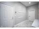 Functional mudroom features a tile floor, coat racks, and a bench providing a convenient transition space at 10628 Walnut Creek W Dr, Carmel, IN 46032