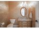Elegant powder room featuring gold wallpaper, granite counters, vanity, and an oval mirror at 10628 Walnut Creek W Dr, Carmel, IN 46032