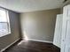 Bedroom featuring wood-look floors, a window, and neutral paint at 11106 Wismar Dr, Indianapolis, IN 46235