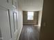 Bedroom featuring wood-look floors, a window, and neutral paint at 11106 Wismar Dr, Indianapolis, IN 46235