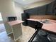 Traditional kitchen with black cabinets, appliances, and pink countertops at 11106 Wismar Dr, Indianapolis, IN 46235