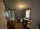 A gray painted bedroom with a double bed in the center and a window overlooking the side yard at 1150 Younce St, Franklin, IN 46131