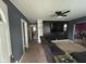 Cozy living room with a dark accent wall and neutral carpet, and an open door to a bathroom at 1150 Younce St, Franklin, IN 46131