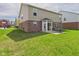 Spacious backyard featuring a lush lawn, brick and vinyl siding, and a patio with outdoor seating at 11840 Geyser Ct, Fishers, IN 46038