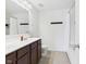 Well-lit bathroom with double sinks, modern fixtures, and a combined tub/shower at 11840 Geyser Ct, Fishers, IN 46038
