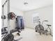 Home exercise room featuring a weight rack, exercise bike, and a stationary bike at 11840 Geyser Ct, Fishers, IN 46038