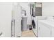 Efficient laundry room featuring modern appliances, ample storage, and tile flooring at 11840 Geyser Ct, Fishers, IN 46038
