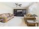 Cozy living room featuring comfortable sofas, a ceiling fan, and built-in shelving at 11840 Geyser Ct, Fishers, IN 46038