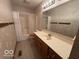 Neutral bathroom with a shower/tub combo, vanity, and decorative wallpaper at 1215 Willow Springs Blvd, Brownsburg, IN 46112