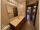 Cozy bathroom with good lighting, vanity, a mirror and entry into the hallway at 1215 Willow Springs Blvd, Brownsburg, IN 46112