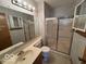 Bathroom featuring a single sink vanity, large mirror, and a step-in shower with sliding glass doors at 1215 Willow Springs Blvd, Brownsburg, IN 46112