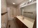 Well-lit bathroom with a large vanity, mirror, and a shower-tub combination at 1215 Willow Springs Blvd, Brownsburg, IN 46112