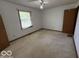 Bedroom featuring neutral carpeting, a window overlooking the yard, and a standard closet at 1215 Willow Springs Blvd, Brownsburg, IN 46112
