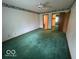 Large bedroom with green carpet, a ceiling fan, and convenient access to ensuite bath at 1215 Willow Springs Blvd, Brownsburg, IN 46112