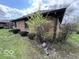 Side view of a brick house with gutters and bushes along the exterior at 1215 Willow Springs Blvd, Brownsburg, IN 46112