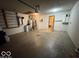 Interior view of garage with a walk-in ramp, utility area, and storage cabinets at 1215 Willow Springs Blvd, Brownsburg, IN 46112