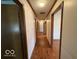 Spacious hallway with wood floors and several doors leading to different rooms at 1215 Willow Springs Blvd, Brownsburg, IN 46112