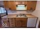 Practical kitchen showcasing wood cabinets, laminate counters, and standard appliances at 1215 Willow Springs Blvd, Brownsburg, IN 46112