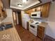 The kitchen features white appliances and light wood cabinets at 1215 Willow Springs Blvd, Brownsburg, IN 46112