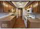 Functional kitchen featuring wood cabinets, laminate countertops, and white appliances at 1215 Willow Springs Blvd, Brownsburg, IN 46112