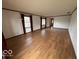 Bright living room featuring hardwood floors, white walls, and natural light from large windows at 1215 Willow Springs Blvd, Brownsburg, IN 46112