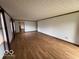 Expansive living room with hardwood floors and bright natural light from the windows at 1215 Willow Springs Blvd, Brownsburg, IN 46112