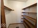 Walk-in closet with built-in wooden shelves at 1215 Willow Springs Blvd, Brownsburg, IN 46112