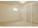 Clean basement space with tile floor, a small window, and doors leading to other areas at 12561 Gladecrest Dr, Carmel, IN 46033