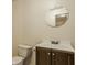 Bathroom featuring a vanity with a dark wood cabinet and a round mirror at 12561 Gladecrest Dr, Carmel, IN 46033
