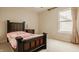 Bedroom featuring a bed, end table, carpet, and a window with curtains at 12561 Gladecrest Dr, Carmel, IN 46033