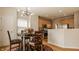 Dining area with modern light fixture, hardwood floors and view of the kitchen at 12561 Gladecrest Dr, Carmel, IN 46033