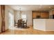 Bright dining area features hardwood floors, modern light fixture, and sliding glass door to the backyard at 12561 Gladecrest Dr, Carmel, IN 46033