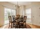 Dining area with hardwood floors, modern lighting, round wood table and a view of the backyard at 12561 Gladecrest Dr, Carmel, IN 46033