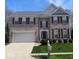 Charming brick two-story home with a two car garage, manicured lawn, and dark shutters at 12561 Gladecrest Dr, Carmel, IN 46033