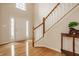 Bright foyer with hardwood floors, stairs, and a view of the front door at 12561 Gladecrest Dr, Carmel, IN 46033