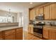 Kitchen with stainless steel appliances, light wood cabinets, and hardwood floors at 12561 Gladecrest Dr, Carmel, IN 46033