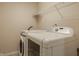 Laundry room with new, modern washer and dryer units, plus wire shelving at 12561 Gladecrest Dr, Carmel, IN 46033