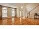 Spacious living room with hardwood floors, lots of natural light, and staircase at 12561 Gladecrest Dr, Carmel, IN 46033
