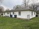 Exterior of home with neat lawn and access to backyard utilities, creating a functional outdoor space at 129 S Boehning St, Indianapolis, IN 46219