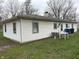 Rear view of home with white siding complemented by a well-maintained yard and functional outdoor space at 129 S Boehning St, Indianapolis, IN 46219