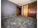 Bedroom with blue walls, carpeting, and a closet for ample storage at 129 S Boehning St, Indianapolis, IN 46219