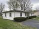 Classic white siding and neatly trimmed hedges surround this traditional home on a green lawn at 129 S Boehning St, Indianapolis, IN 46219