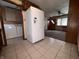 Open kitchen with large refrigerator, washer, dryer, and views into a living area, great for multitasking at 129 S Boehning St, Indianapolis, IN 46219