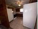 Traditional kitchen design featuring appliances, ceiling fan, and tile flooring, creating a functional cooking space at 129 S Boehning St, Indianapolis, IN 46219