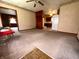 Spacious living room featuring neutral carpeting and a clear view into the kitchen area at 129 S Boehning St, Indianapolis, IN 46219