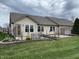 Charming backyard with a lush lawn, brick-lined flower beds, and a cozy patio area at 1302 Lexington Trl, Greenfield, IN 46140